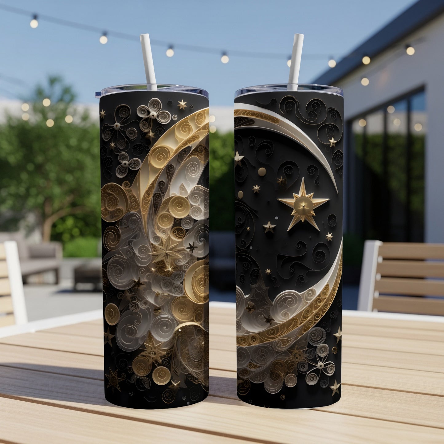 Two black tumblers with gold celestial moon and star designs.