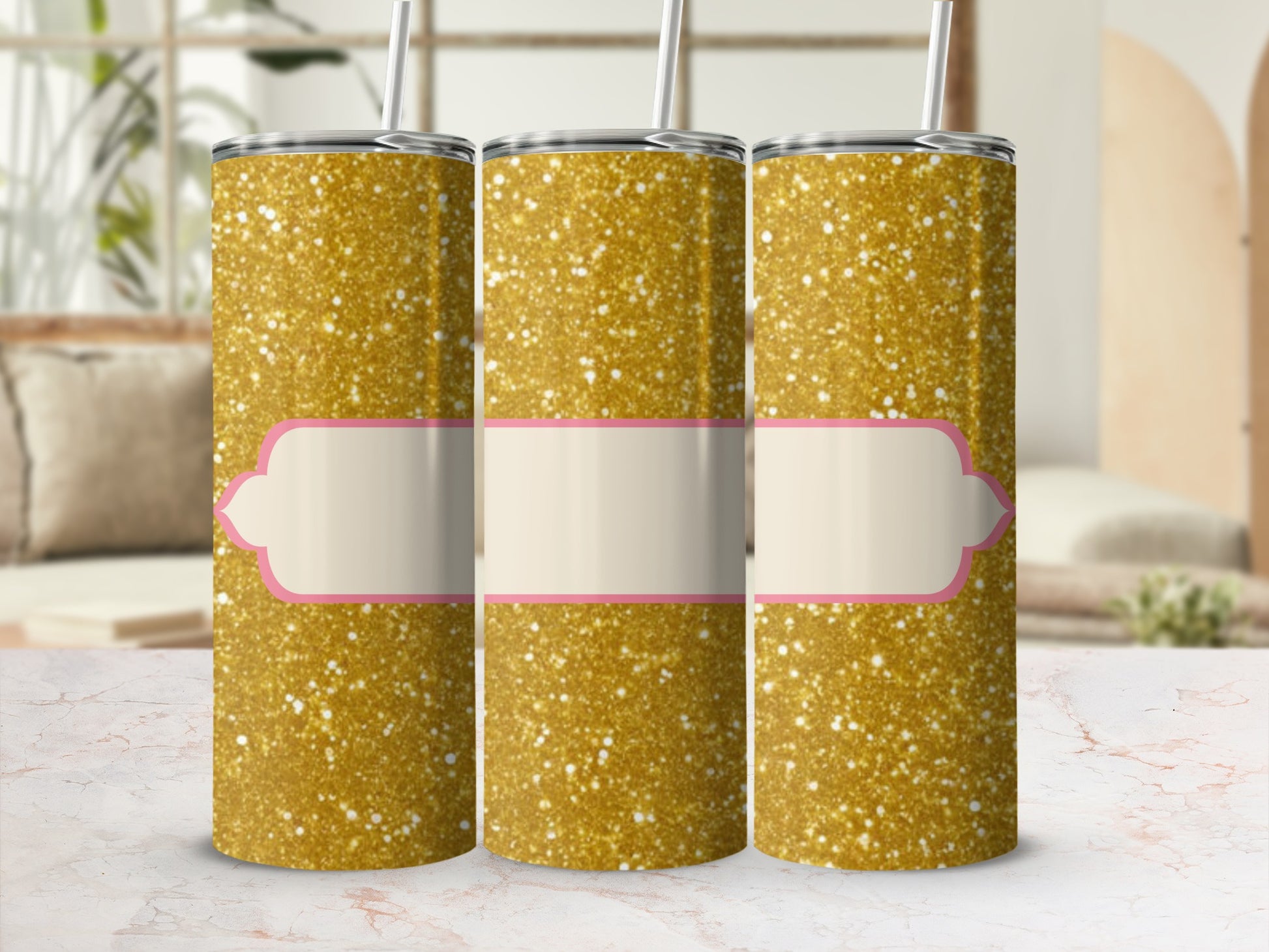 Three gold glitter tumblers with blank cream and pink labels.