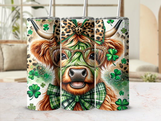 Cow with glasses and bow tie, surrounded by shamrocks and glitter.