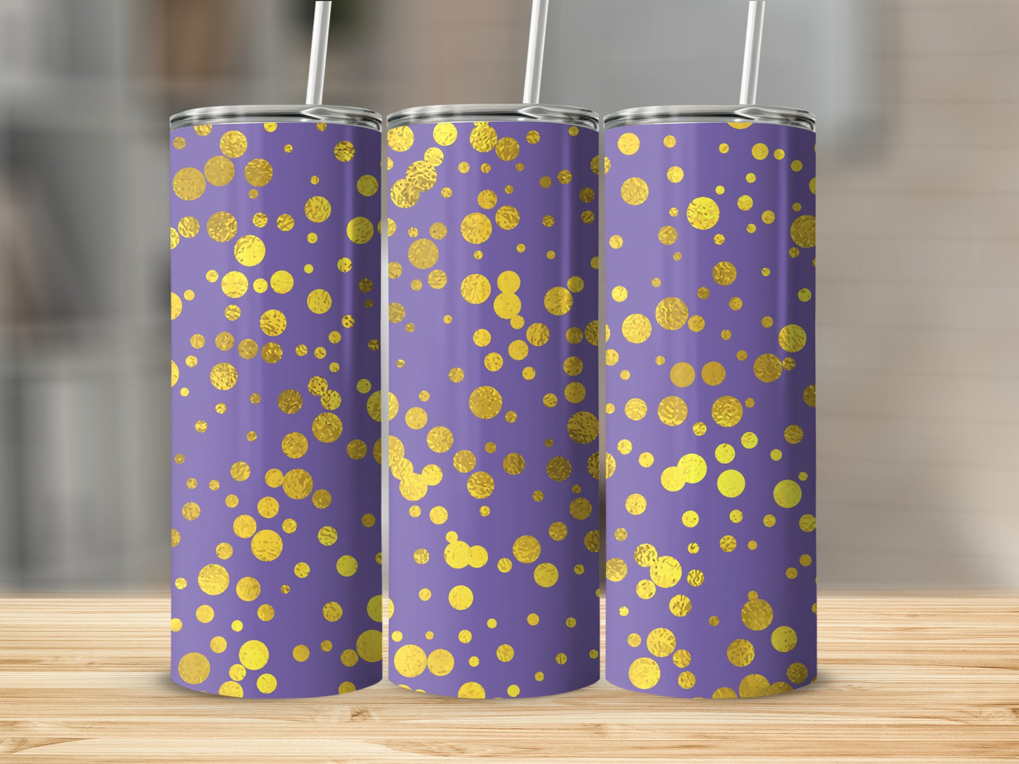 Three purple tumblers with gold polka dot pattern and straws.