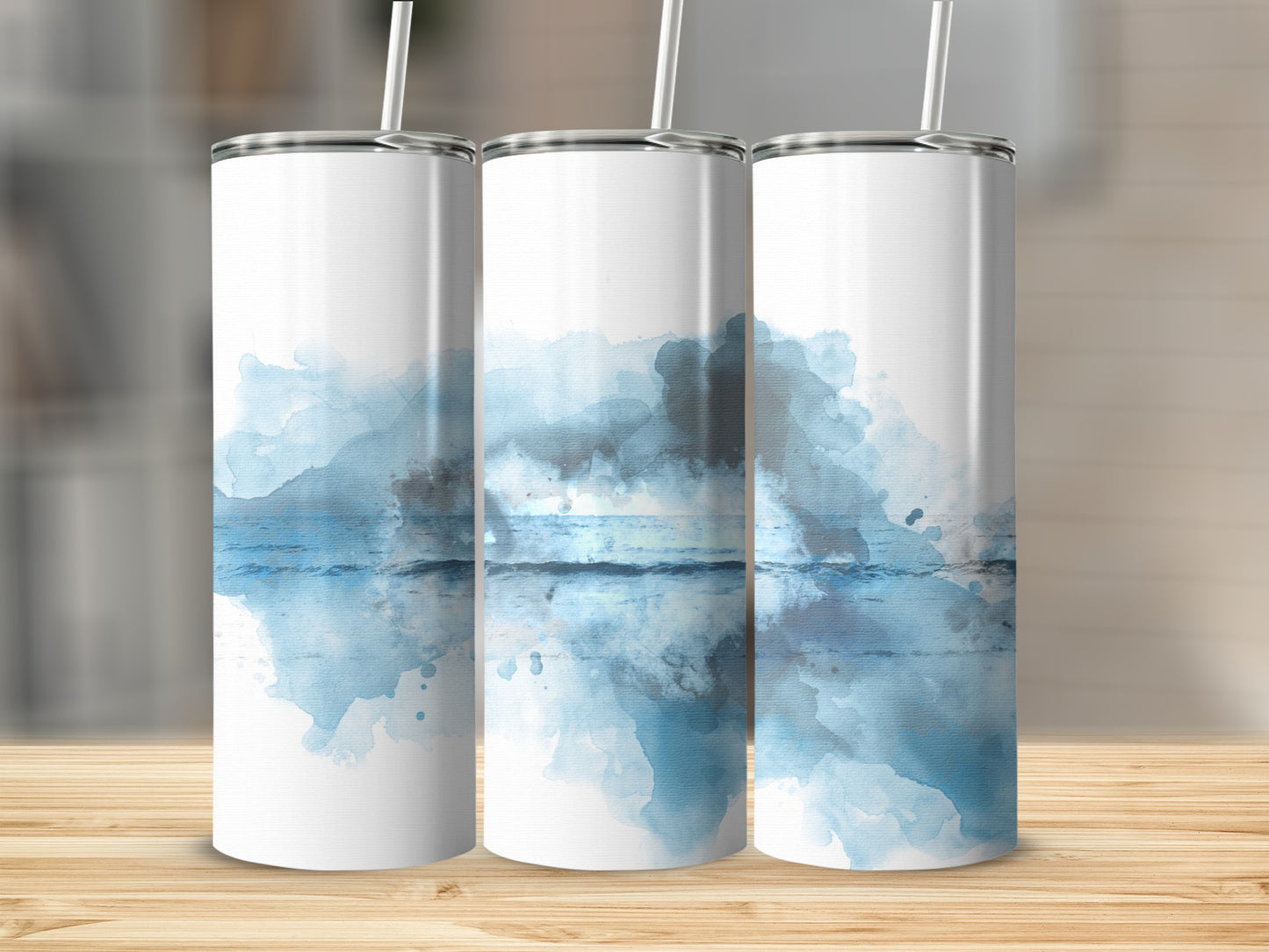 Three white tumblers with abstract blue watercolor ocean and sky design.