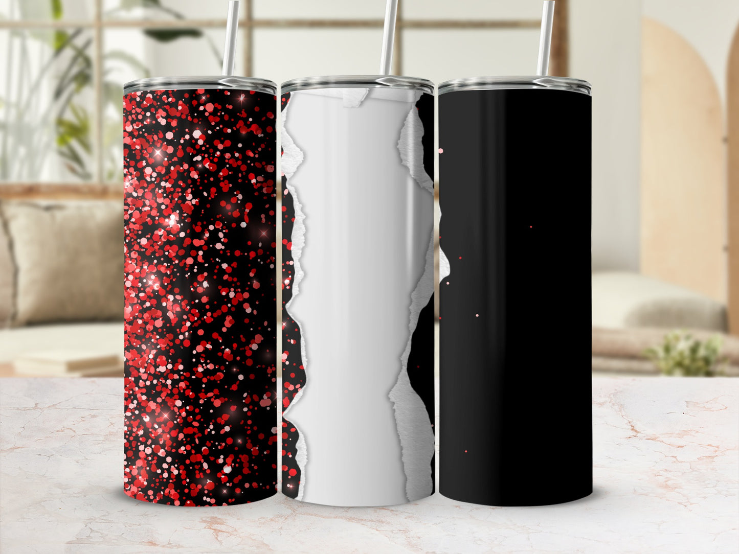 Three stainless steel tumblers with glitter, torn paper, and black designs.