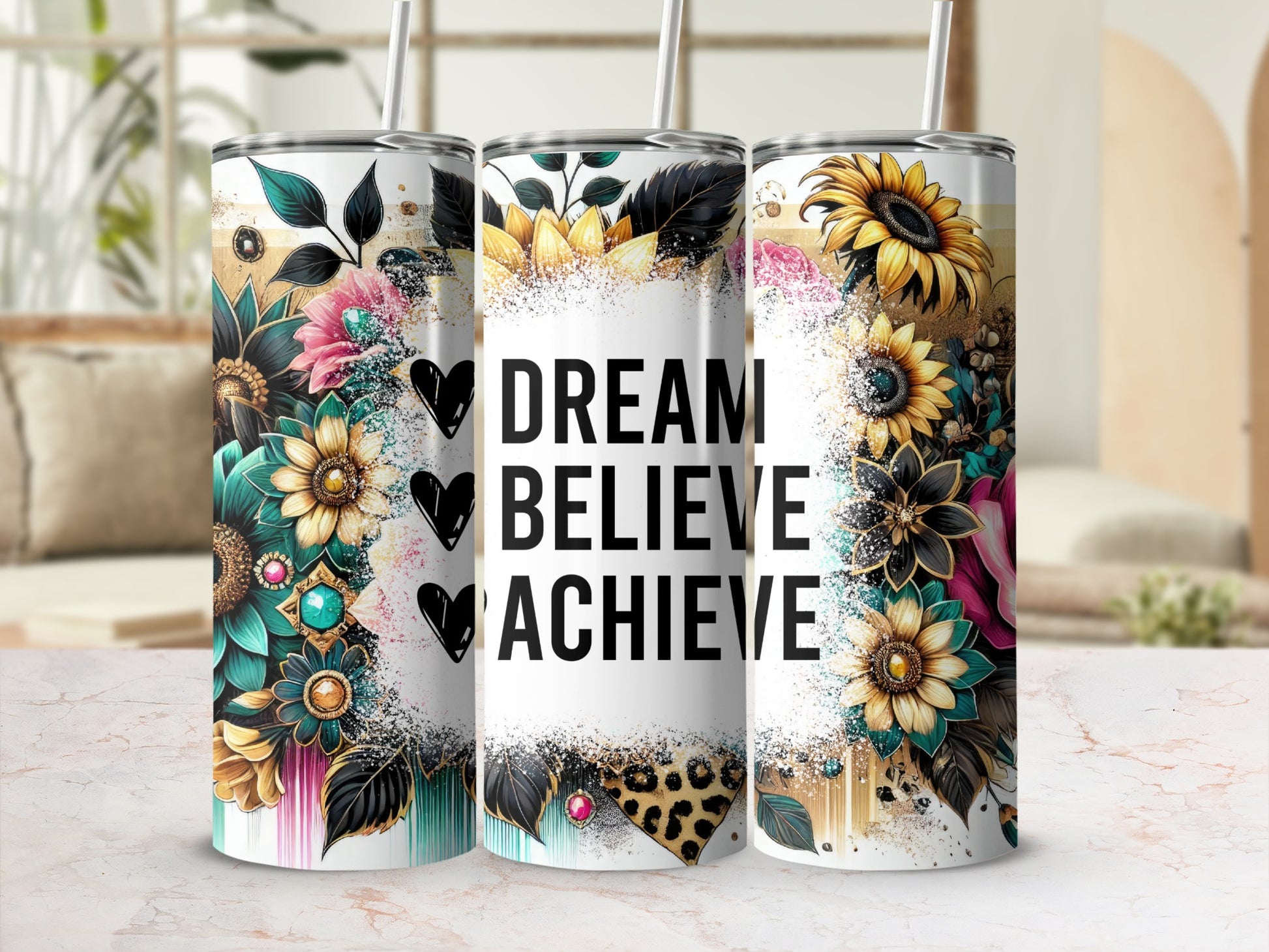 Tumblers with floral designs and "DREAM BELIEVE ACHIEVE" text.