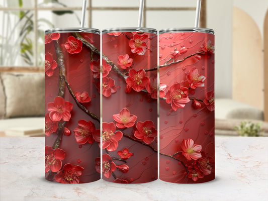 Red floral tumbler with raised cherry blossom design and straw.