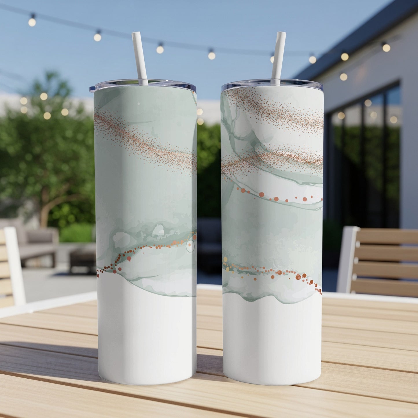 Two white tumblers with a green marbled pattern and rose gold glitter accents.
