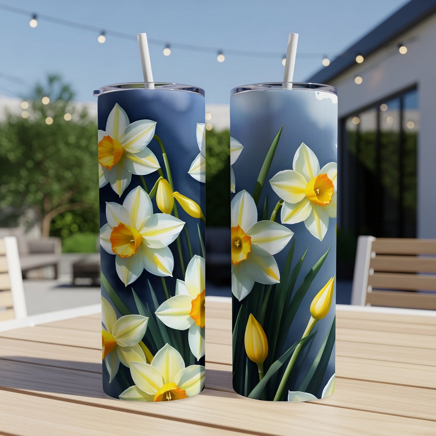 Two tumblers with a close-up floral daffodil print, on a table outdoors.