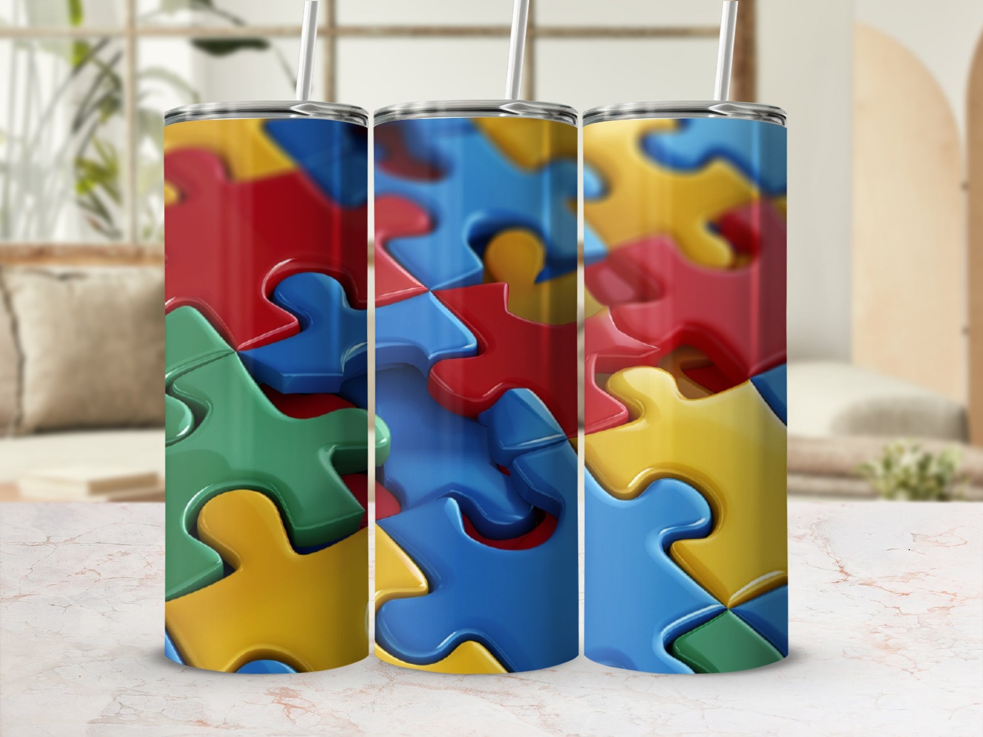 Three colorful puzzle piece tumblers with straws.