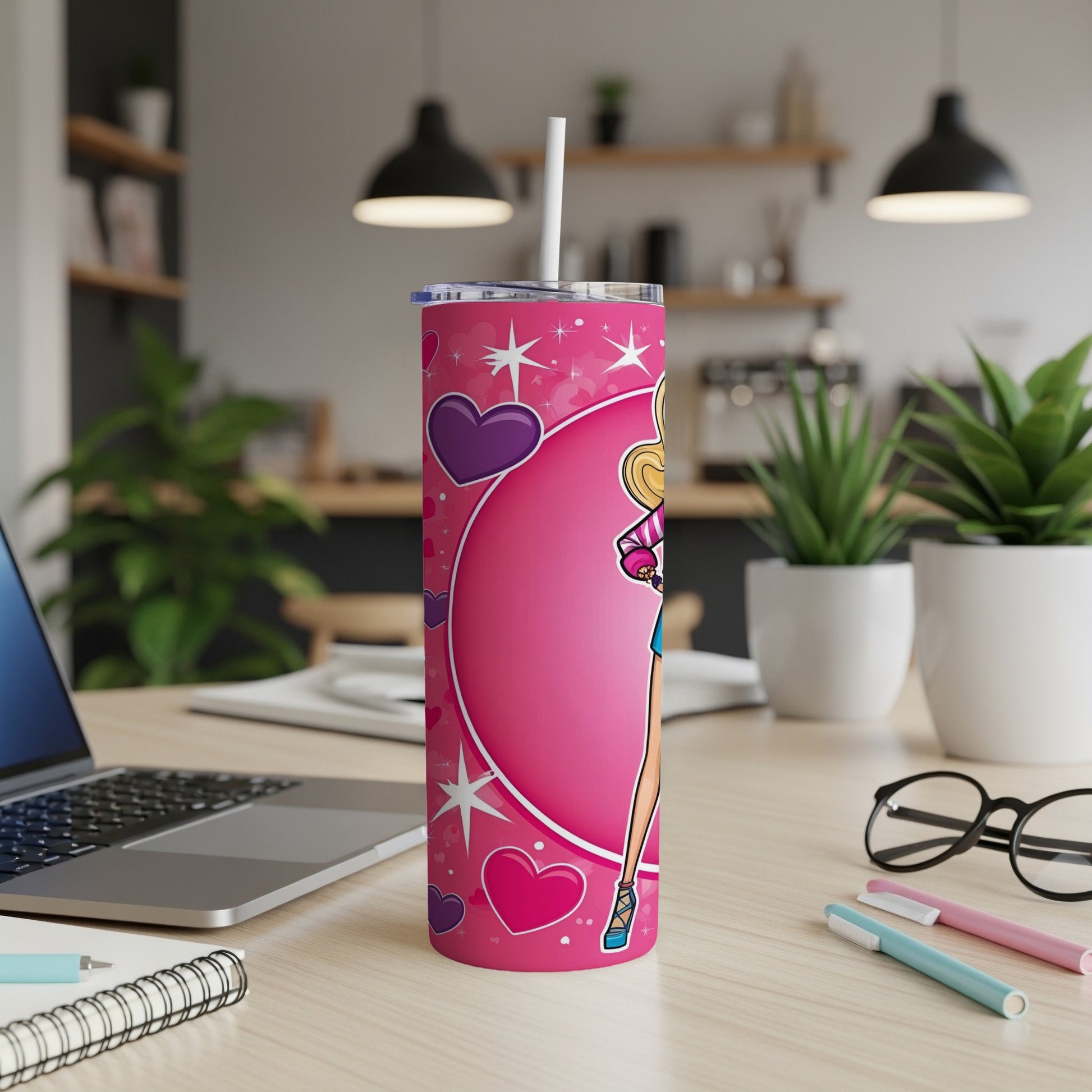 Pink tumbler with Barbie illustration and hearts, on a desk.