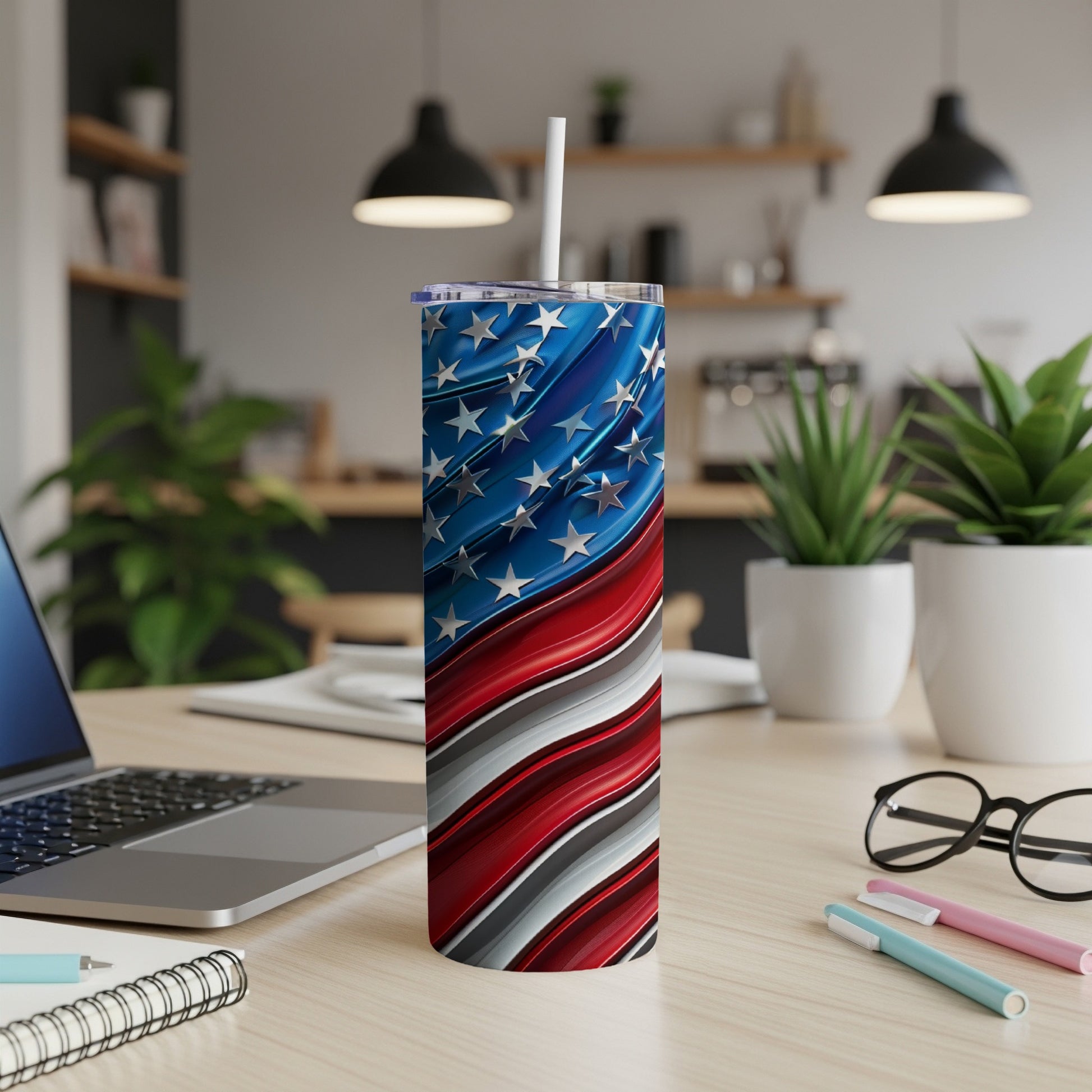 American flag patriotic tumbler with white straw on a desk.