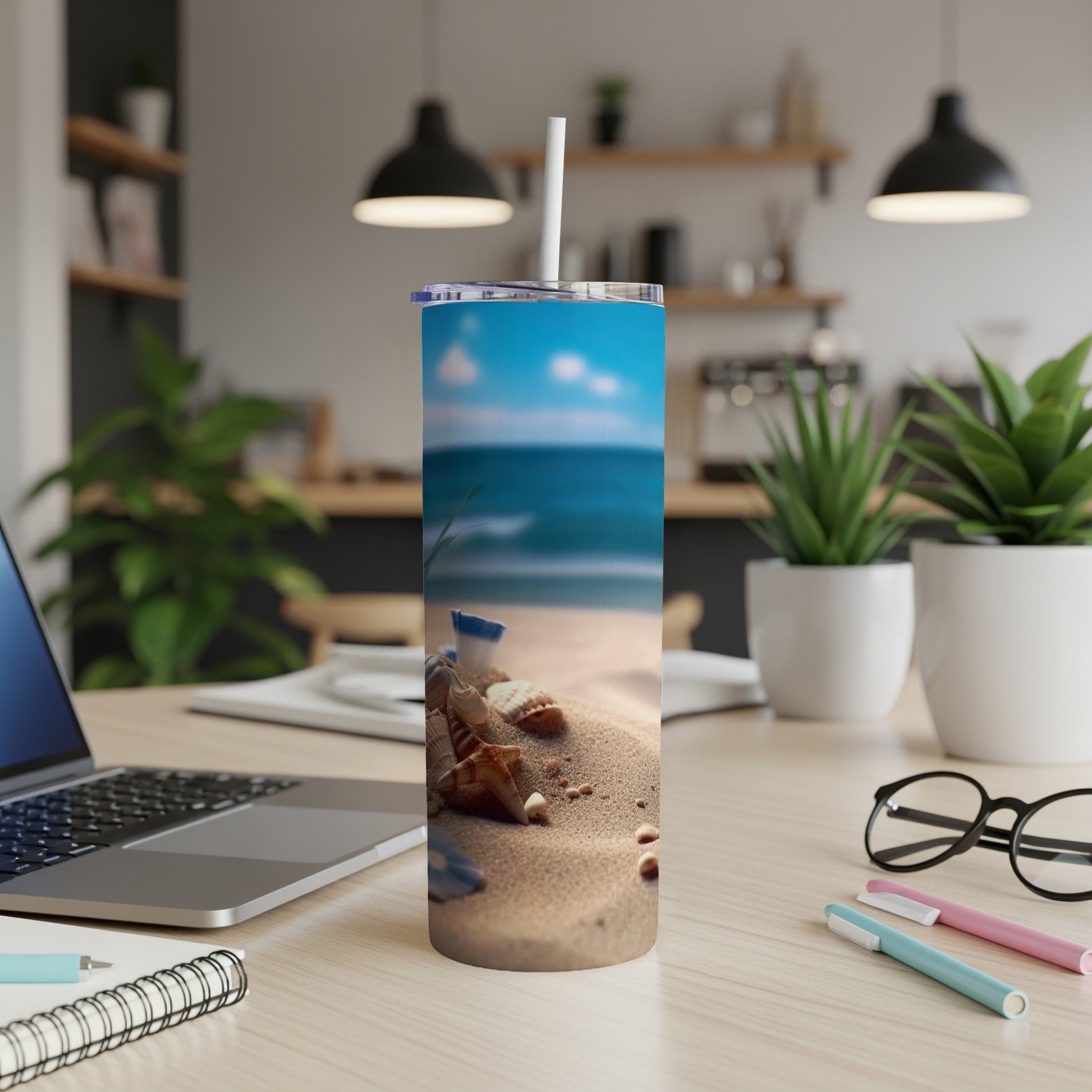 Seashells and beach scene on a white insulated tumbler with straw.