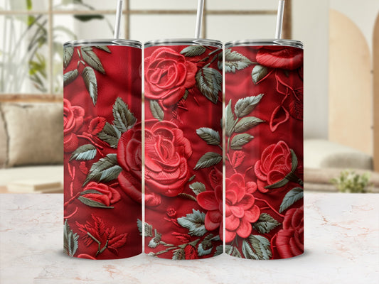 Red roses and leaves embossed on three tumblers with straws.
