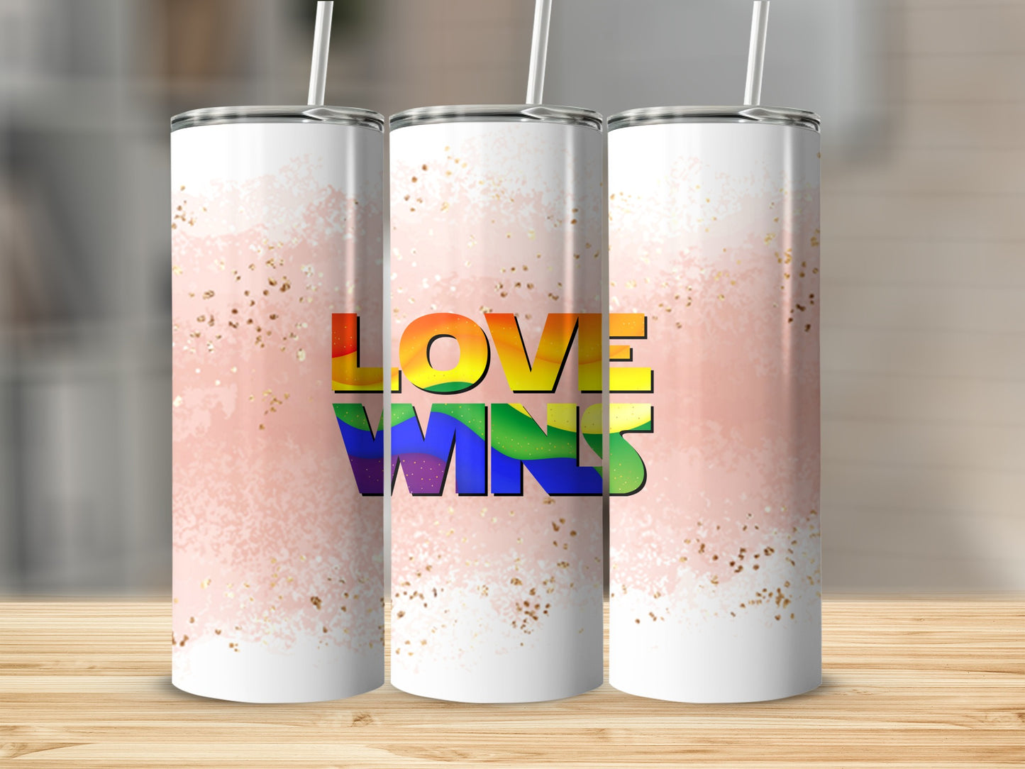Three tumblers with rainbow "Love Wins" text on pink watercolor background.