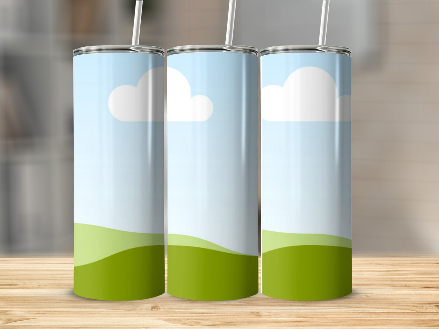 Three tumblers with a blue sky, white clouds, and green rolling hills design.