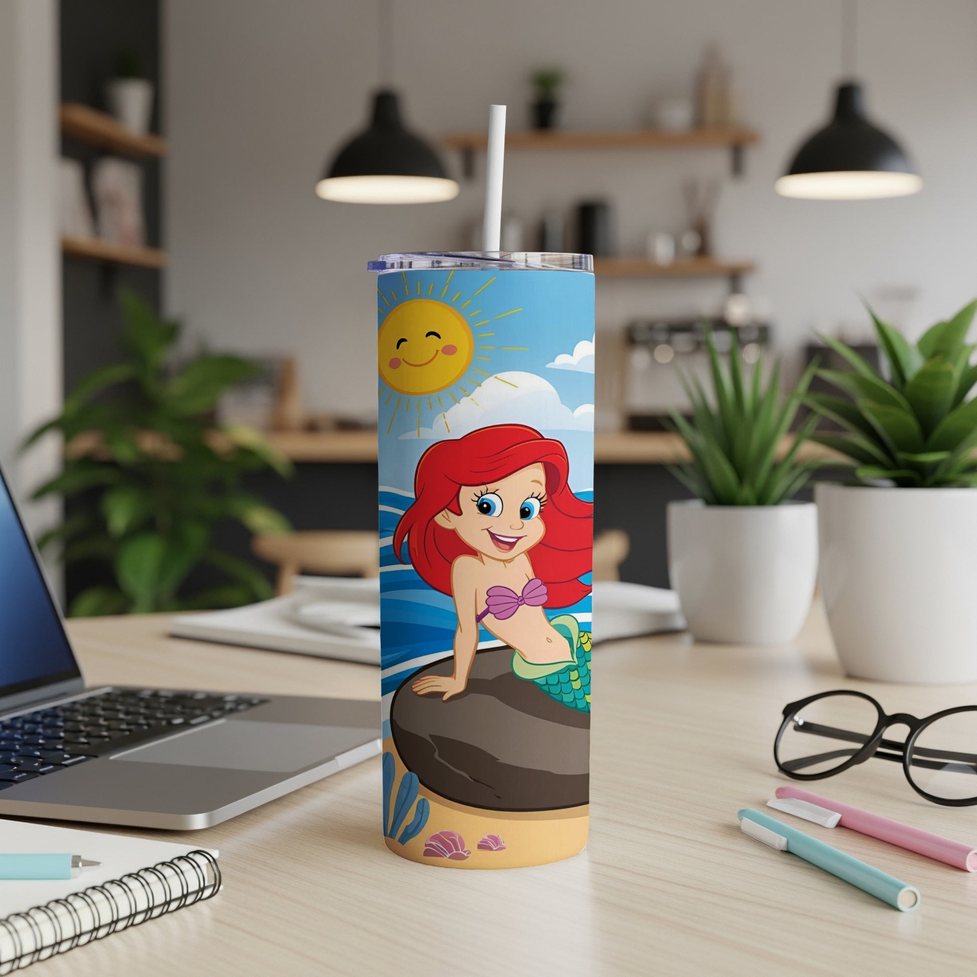 Ariel the mermaid sits on a rock with the sun shining above.