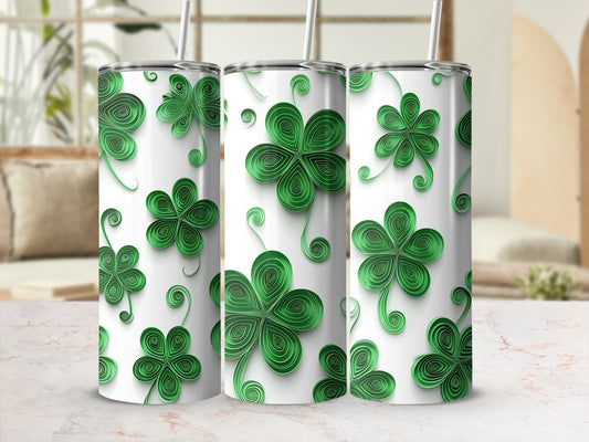 Green clover pattern on three white tumblers with straws.