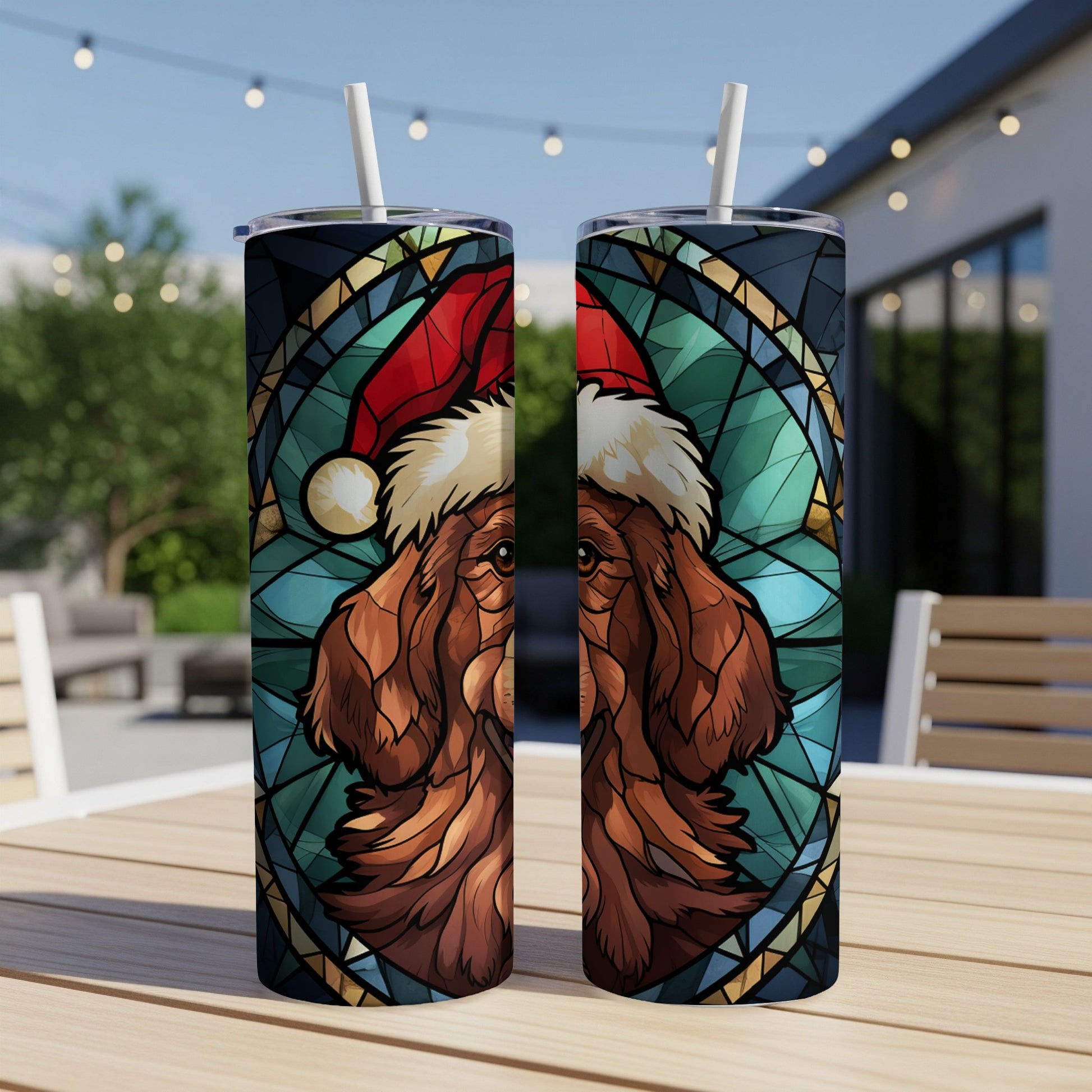 Two tumblers with a stained-glass style dog wearing a Santa hat.