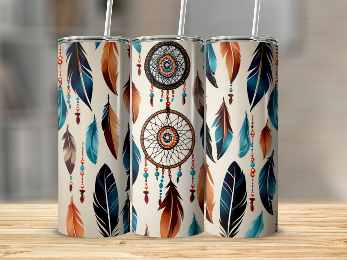 Three tumblers with a dreamcatcher and feather design on a wooden surface.
