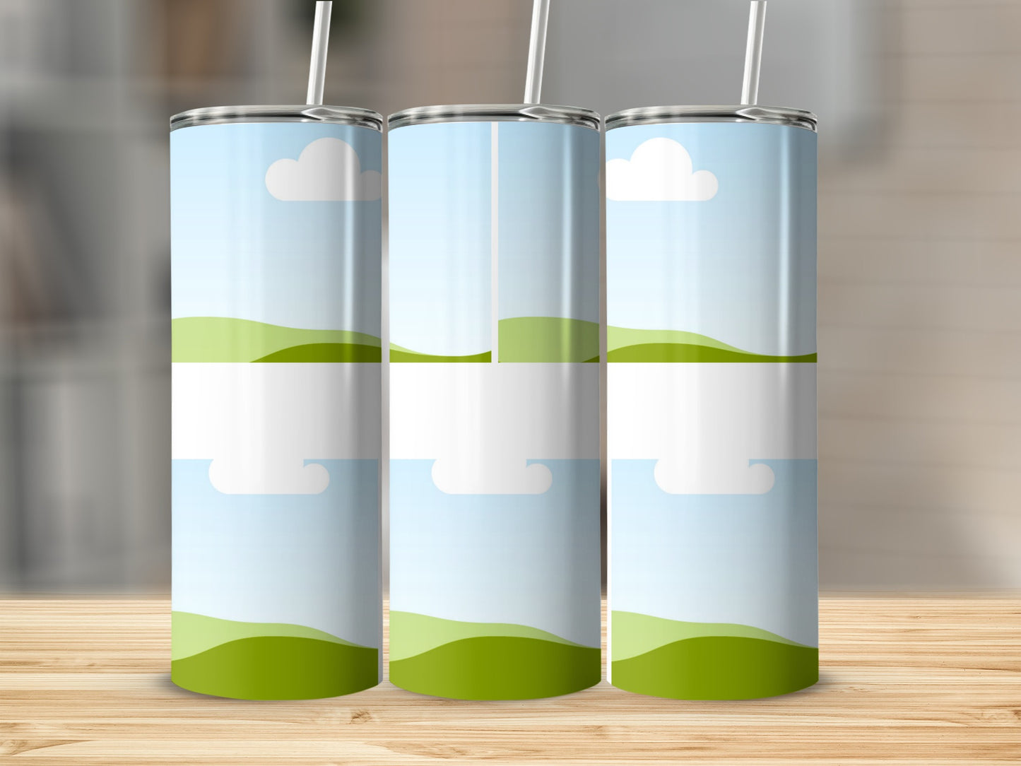 Three blank tumblers with sky and rolling green hills graphic design.