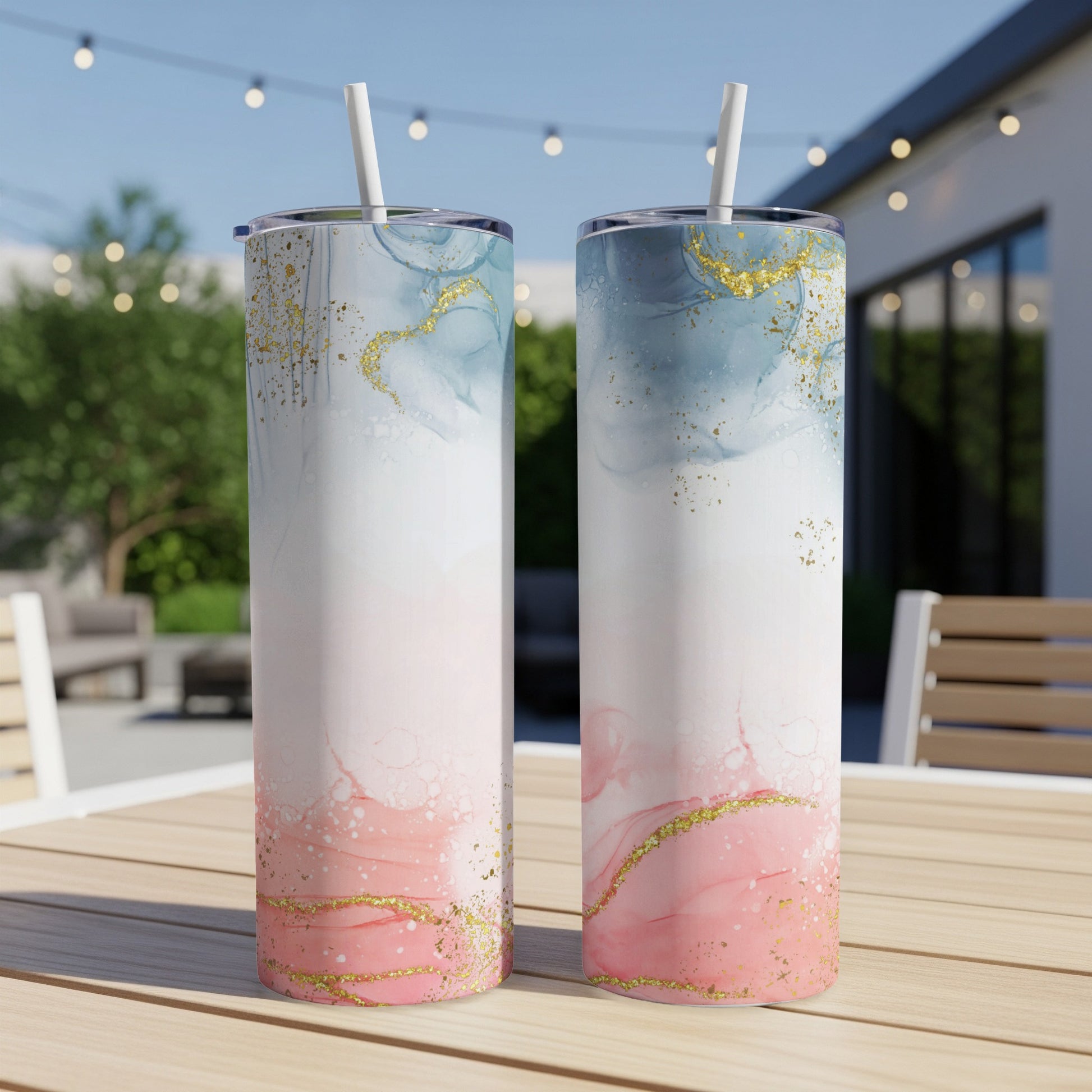 Two tumblers with pink and blue marble design and gold glitter.