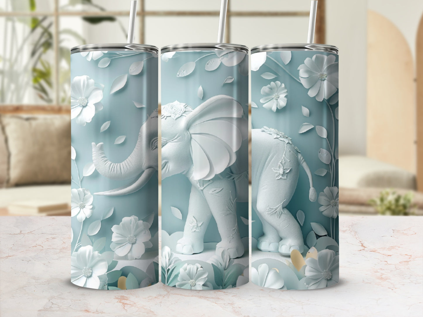 White elephant and floral design on a light blue tumbler.