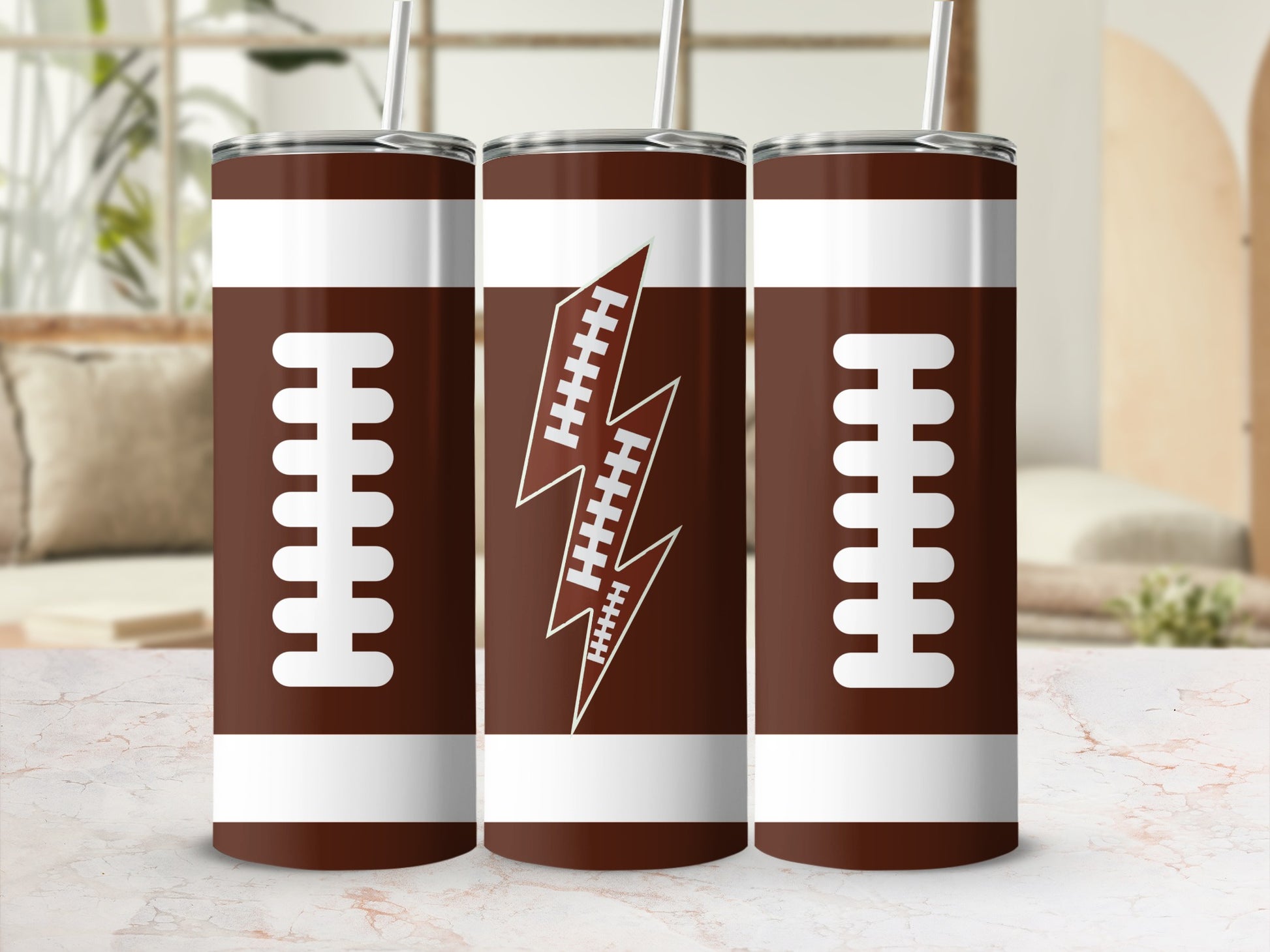 Three brown tumblers with white laces and a lightning bolt football logo.