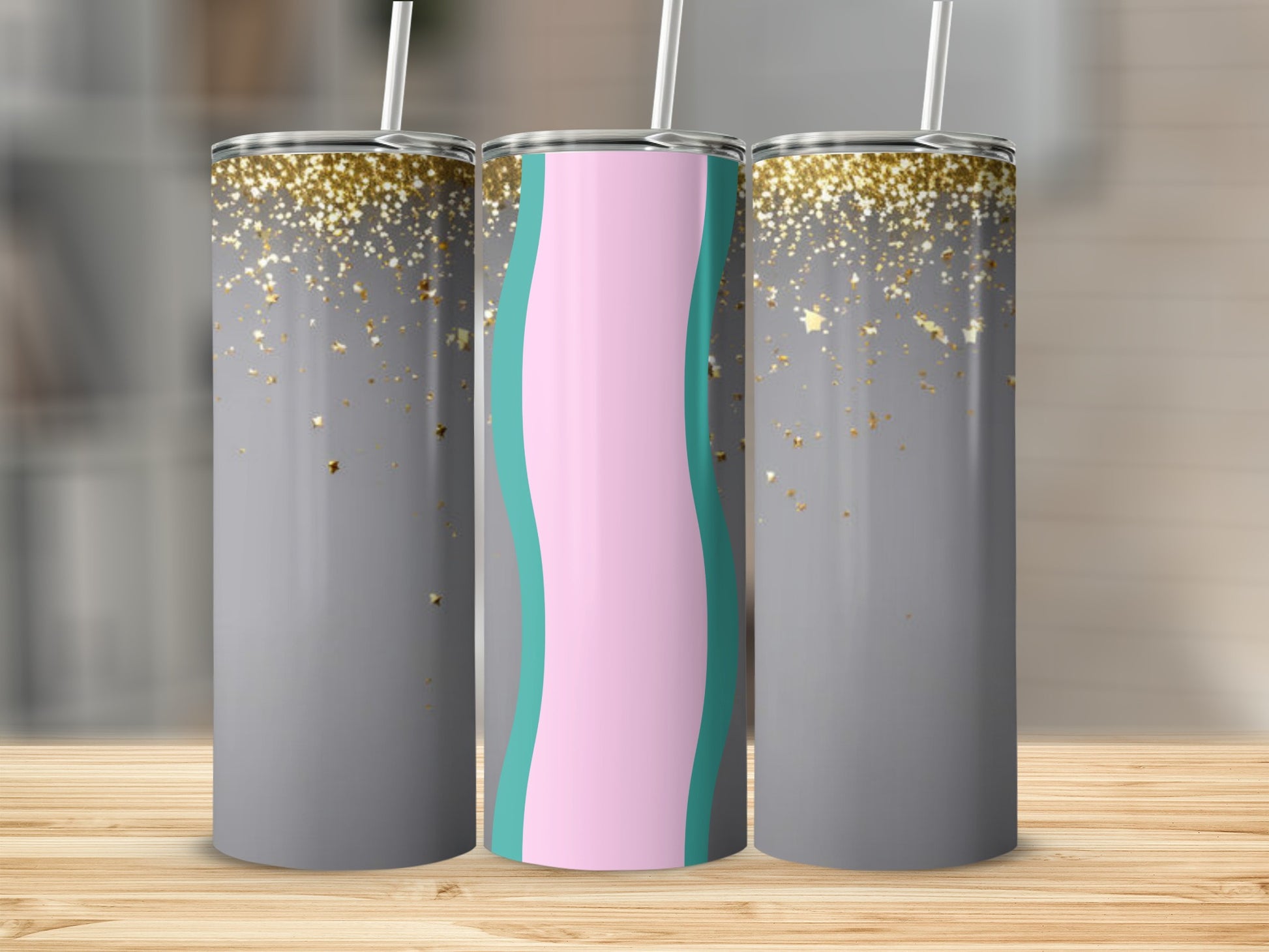 Three tumblers with grey, gold stars, and pink and blue wave designs.