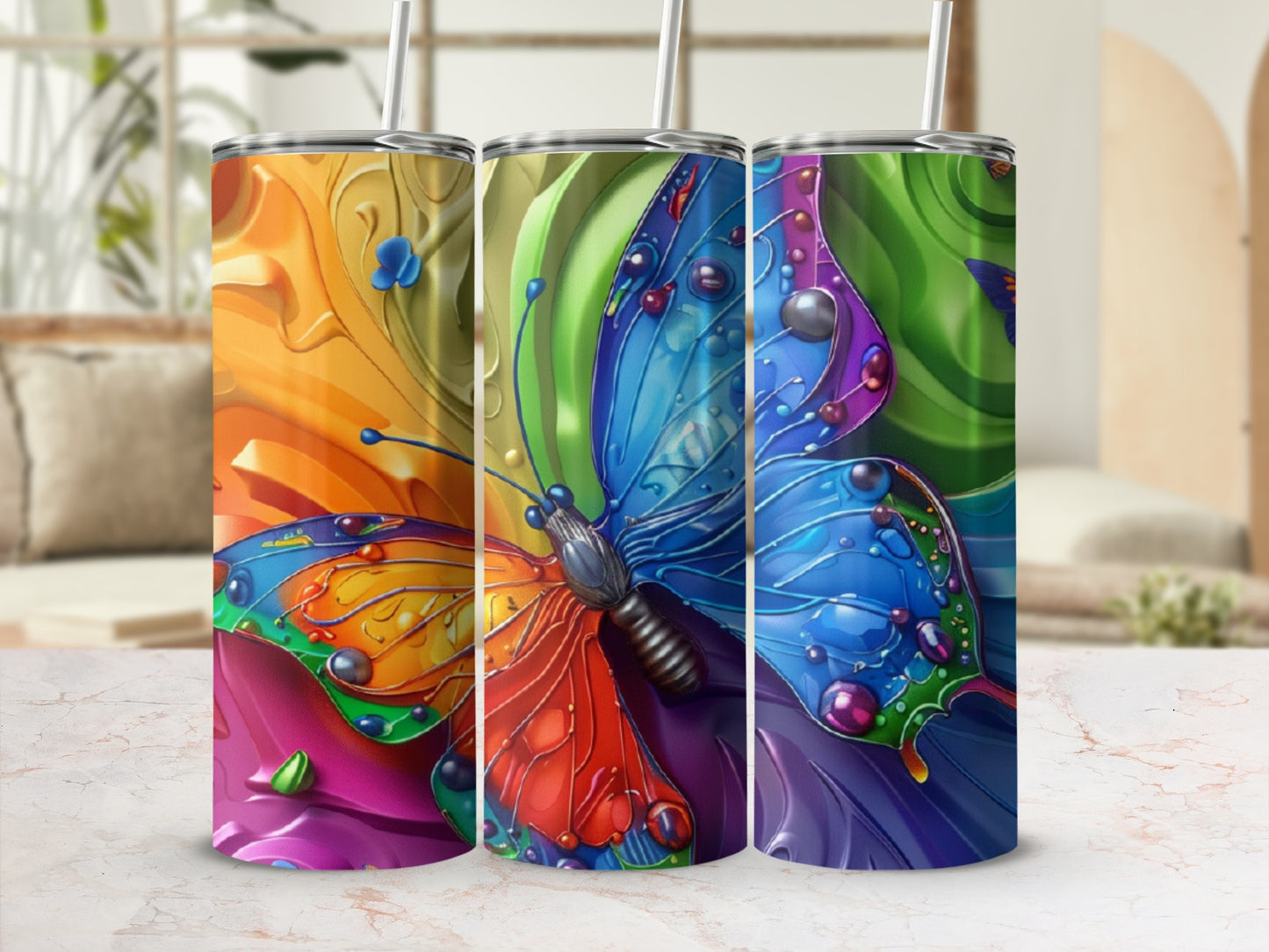 Three colorful tumblers with butterfly and abstract patterns.