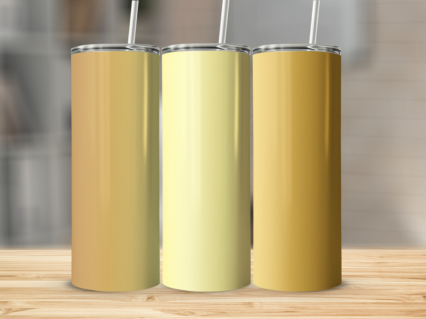 Three tall tumblers in gradient shades of yellow and orange on a wooden surface.