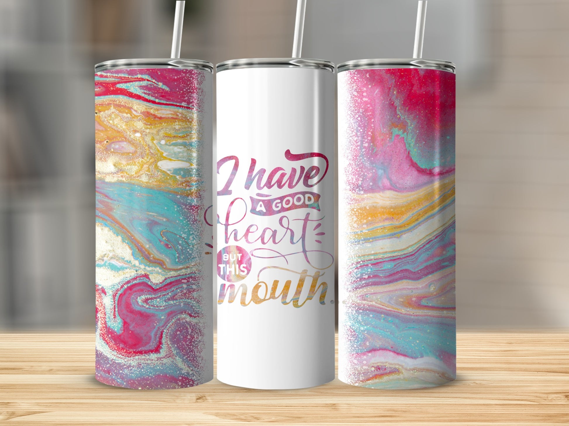 Tumbler with marbled pink, blue, and gold design and "I have a good heart but this mouth" text.
