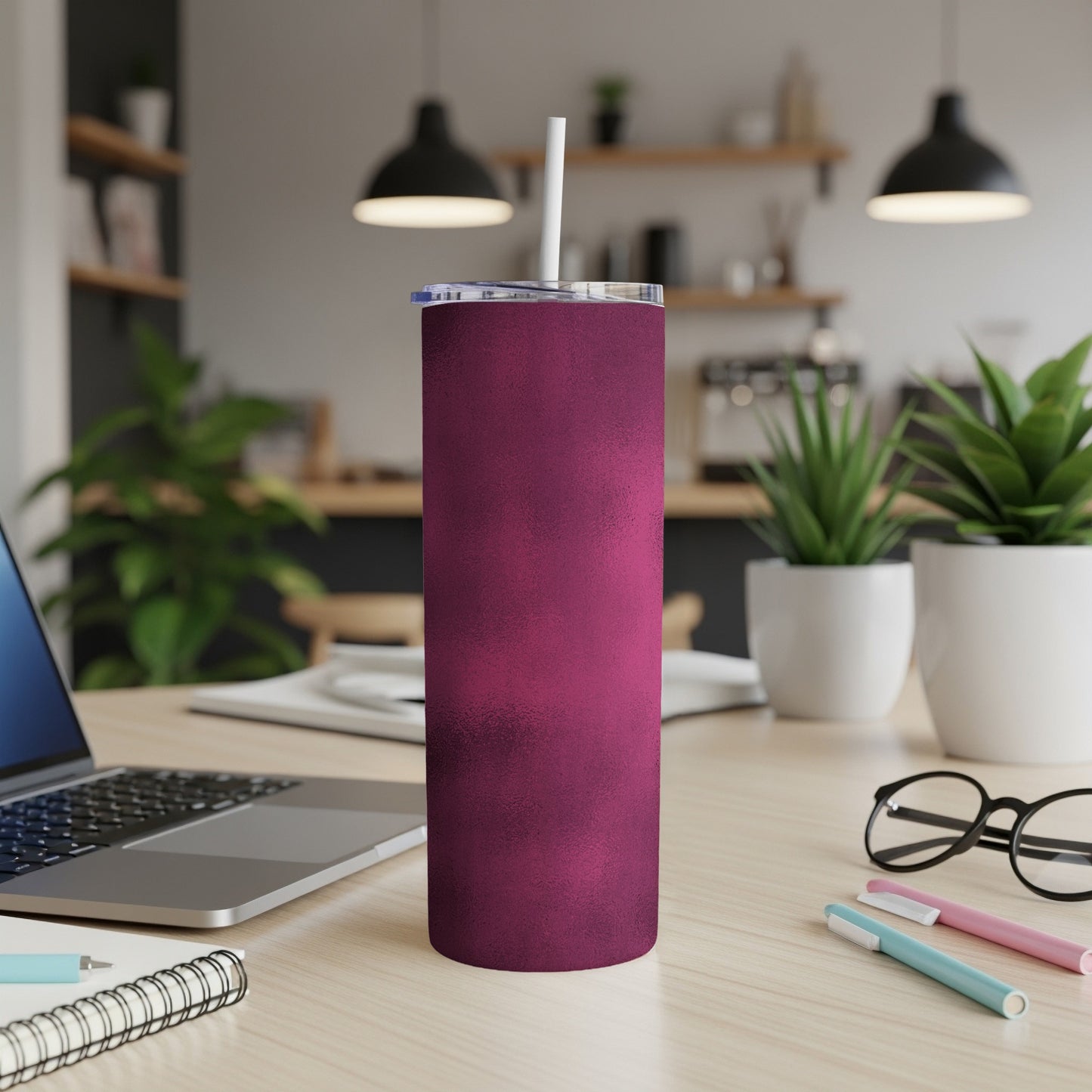 Matte berry textured tumbler with straw on a desk.