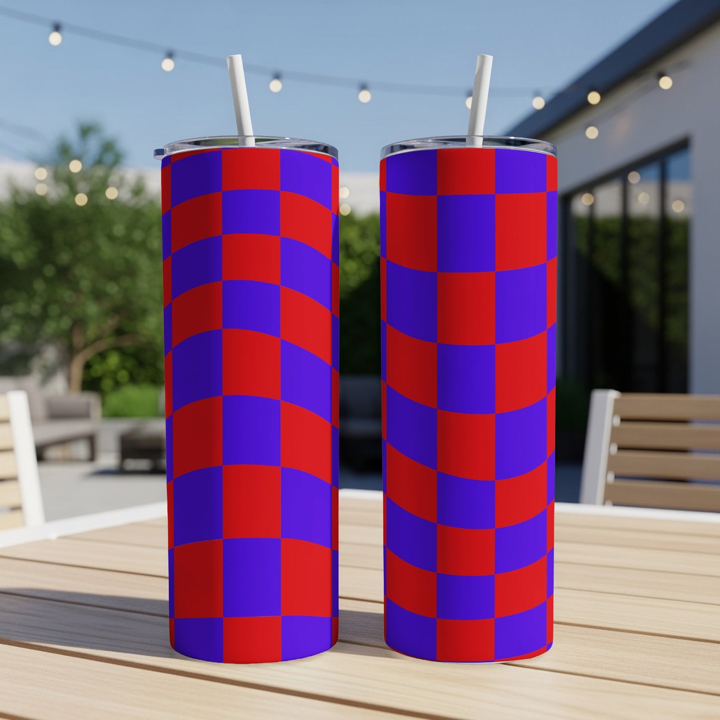 Two tall tumblers with a red and blue checkerboard pattern on a wooden table.