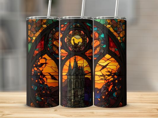 Stained glass tumbler design with a spooky tower and birds against an orange sky.