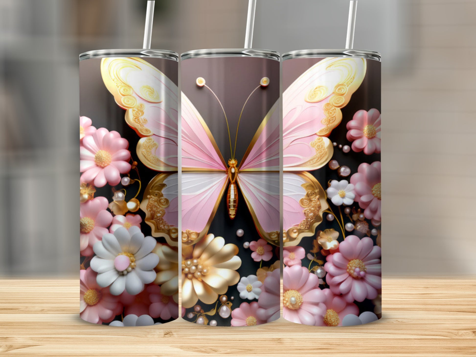 Pink and gold butterfly with flowers on a set of three tumblers.