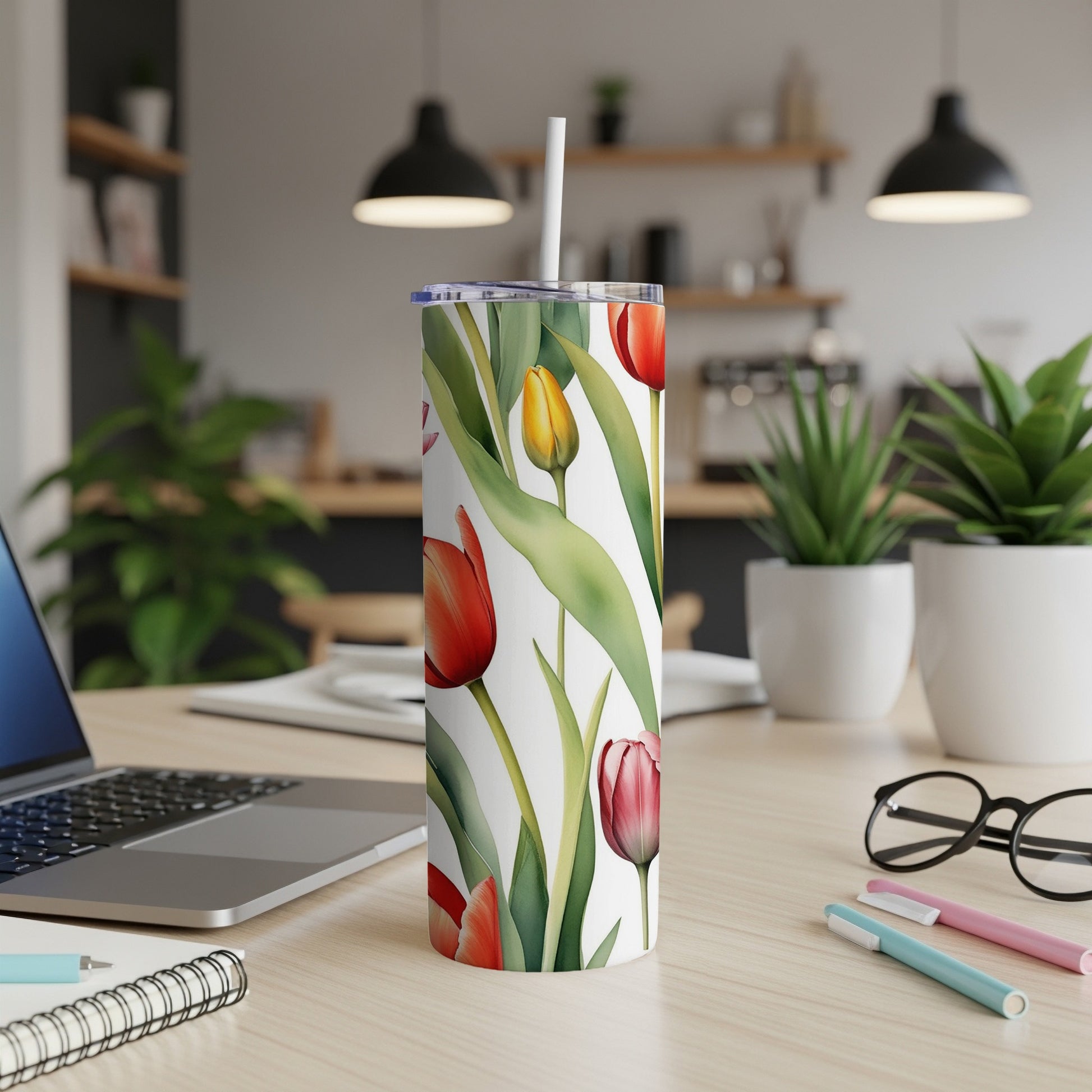 Red and yellow tulips pattern on a white tumbler with a straw.