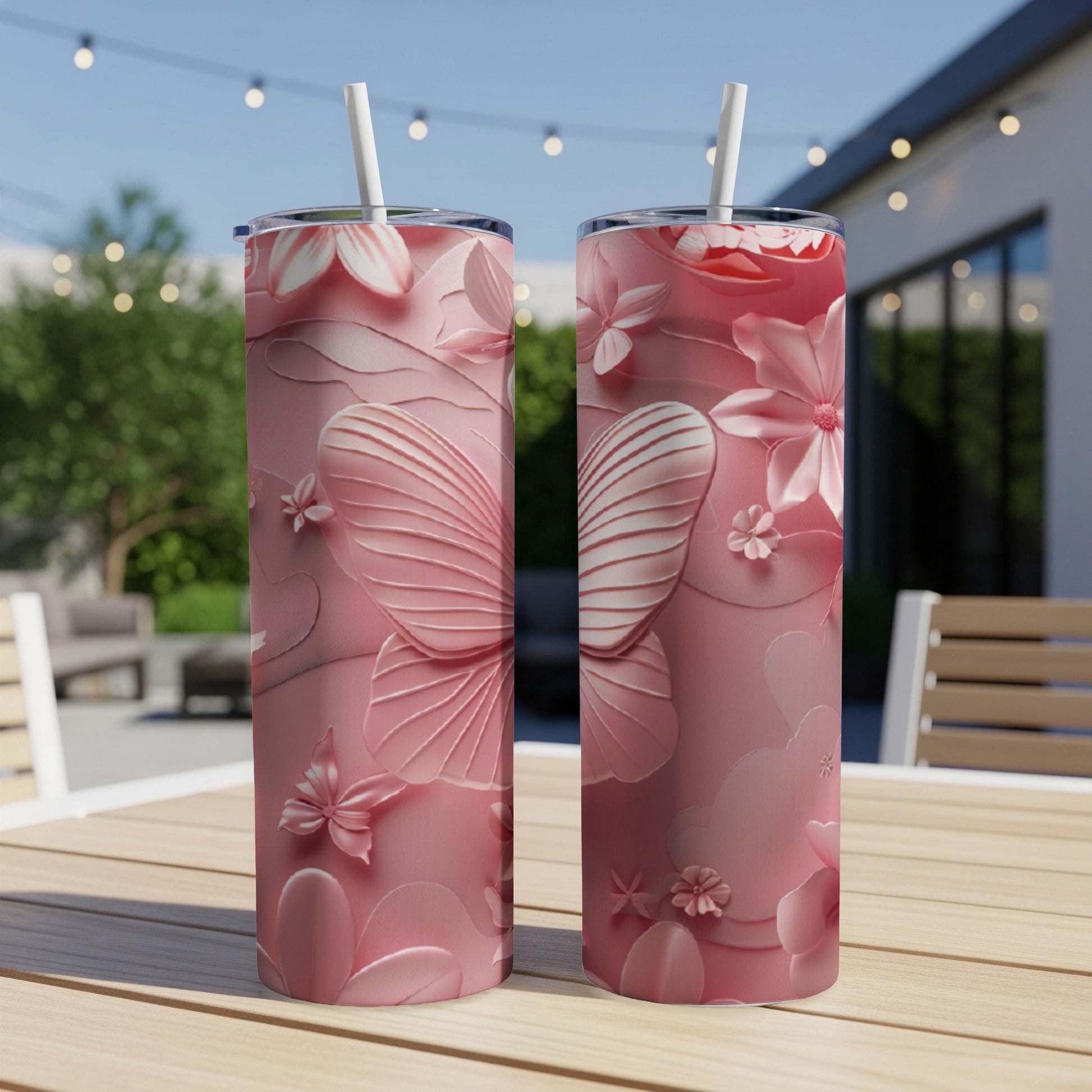 Two pink tumblers with floral and butterfly embossed designs.