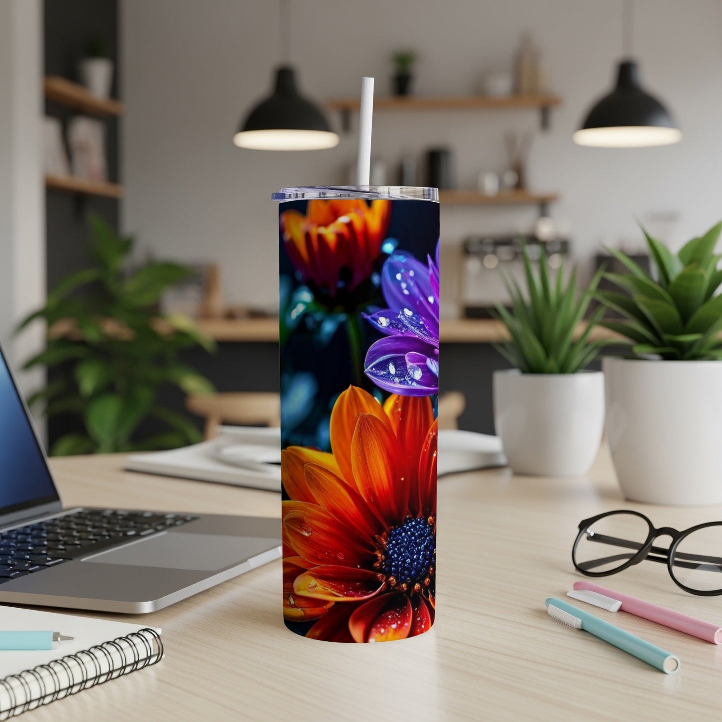 Tall tumbler with colorful daisy design and water droplets.