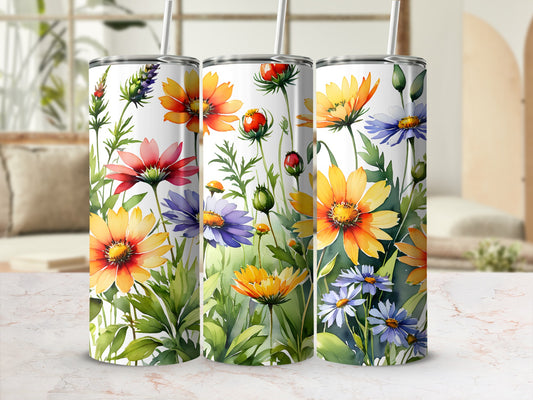 Three tumblers with watercolor floral designs featuring sunflowers and daisies.