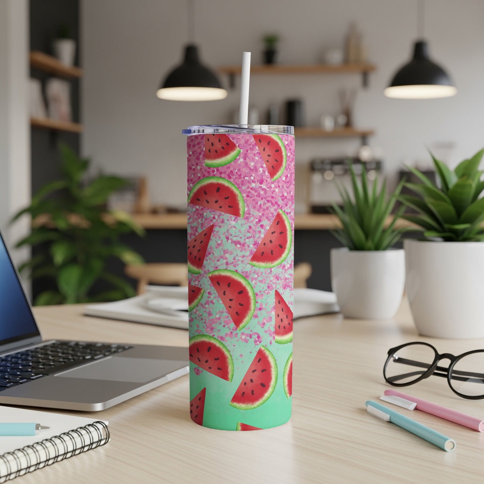 Tall tumbler with watermelon slices and pink glitter on a mint green background.