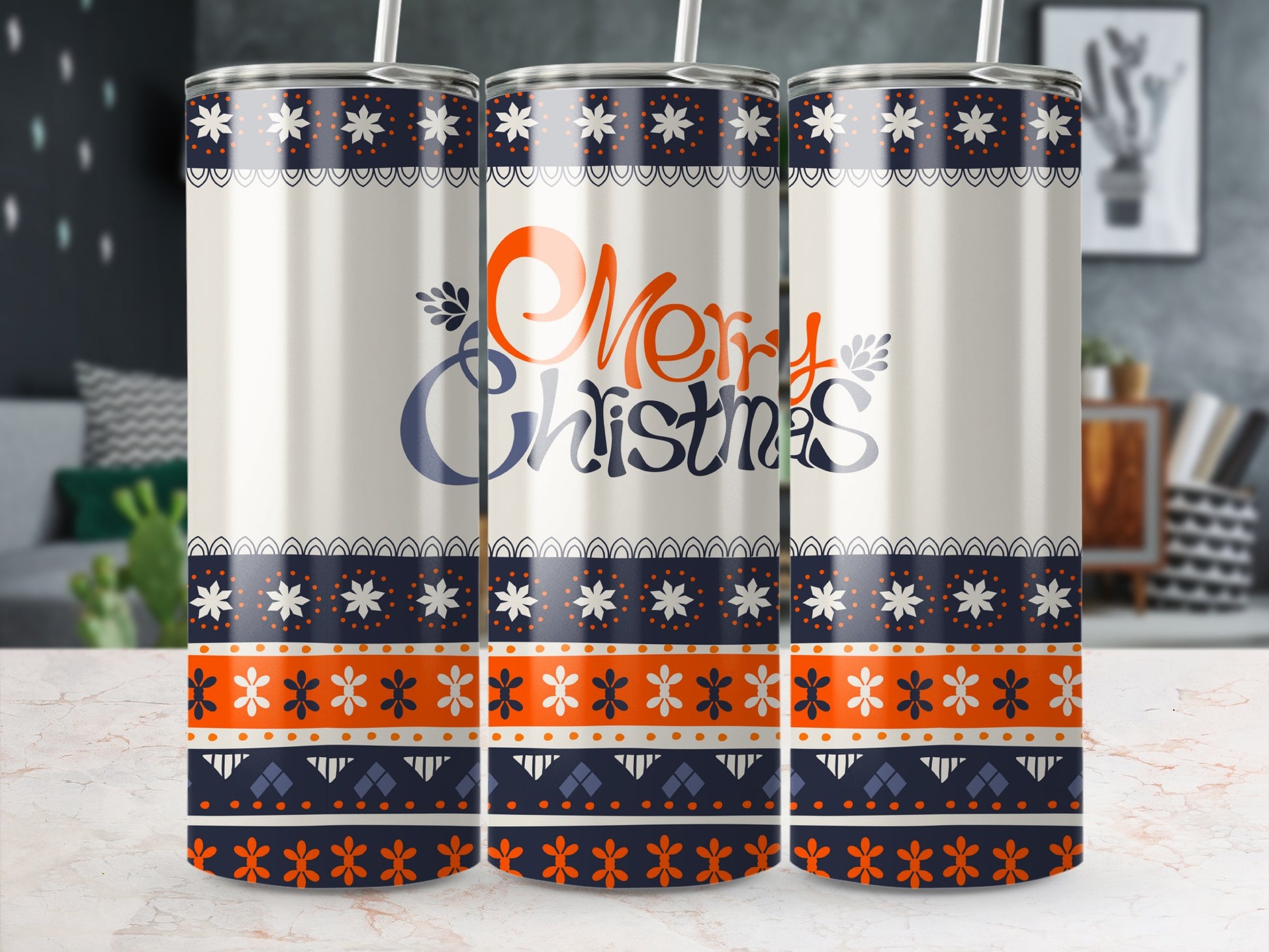 Three Merry Christmas tumblers with blue, orange, and white geometric patterns.