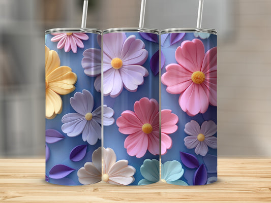 Three tumblers with pastel floral designs displayed on a wooden surface.