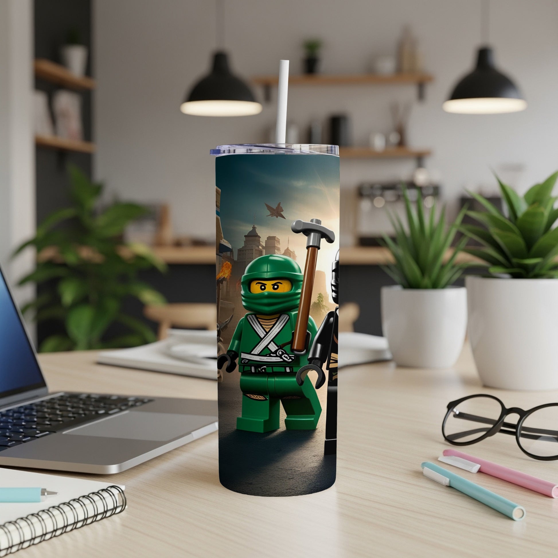 Green Lego ninja with sword and axe, holding a tumbler on a desk.