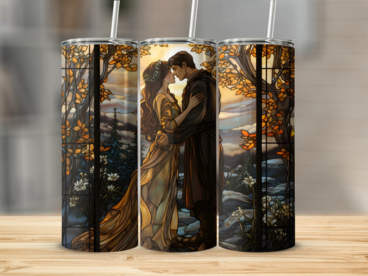 Stained glass tumbler with couple embracing amidst autumn trees and flowers.