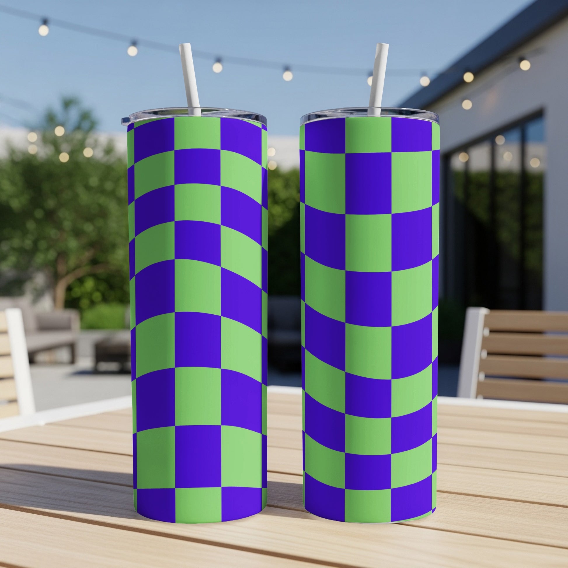 Two tall tumblers with purple and green checkerboard pattern on a wooden table.