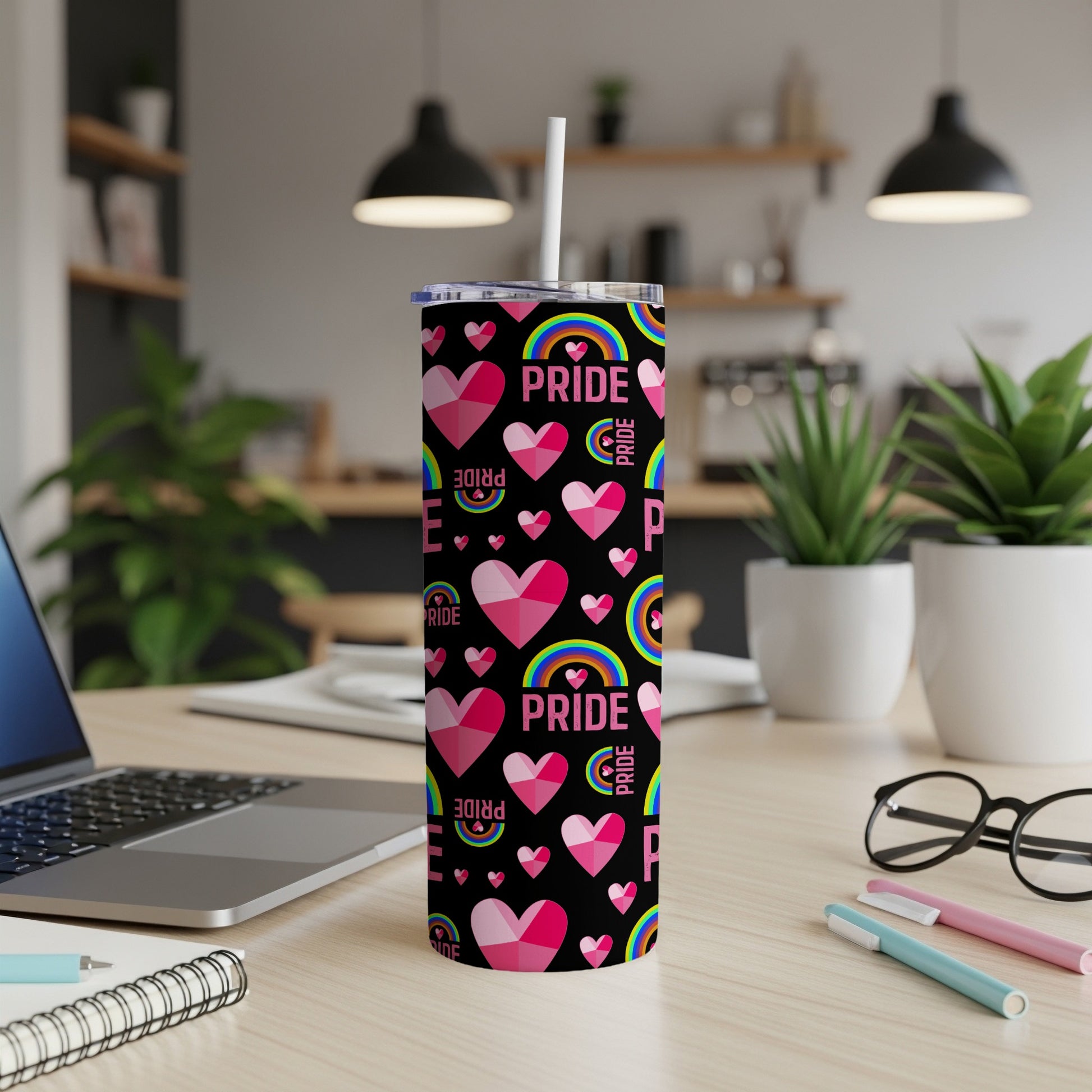 Pink hearts, rainbows, and "Pride" text on a black tumbler with straw.
