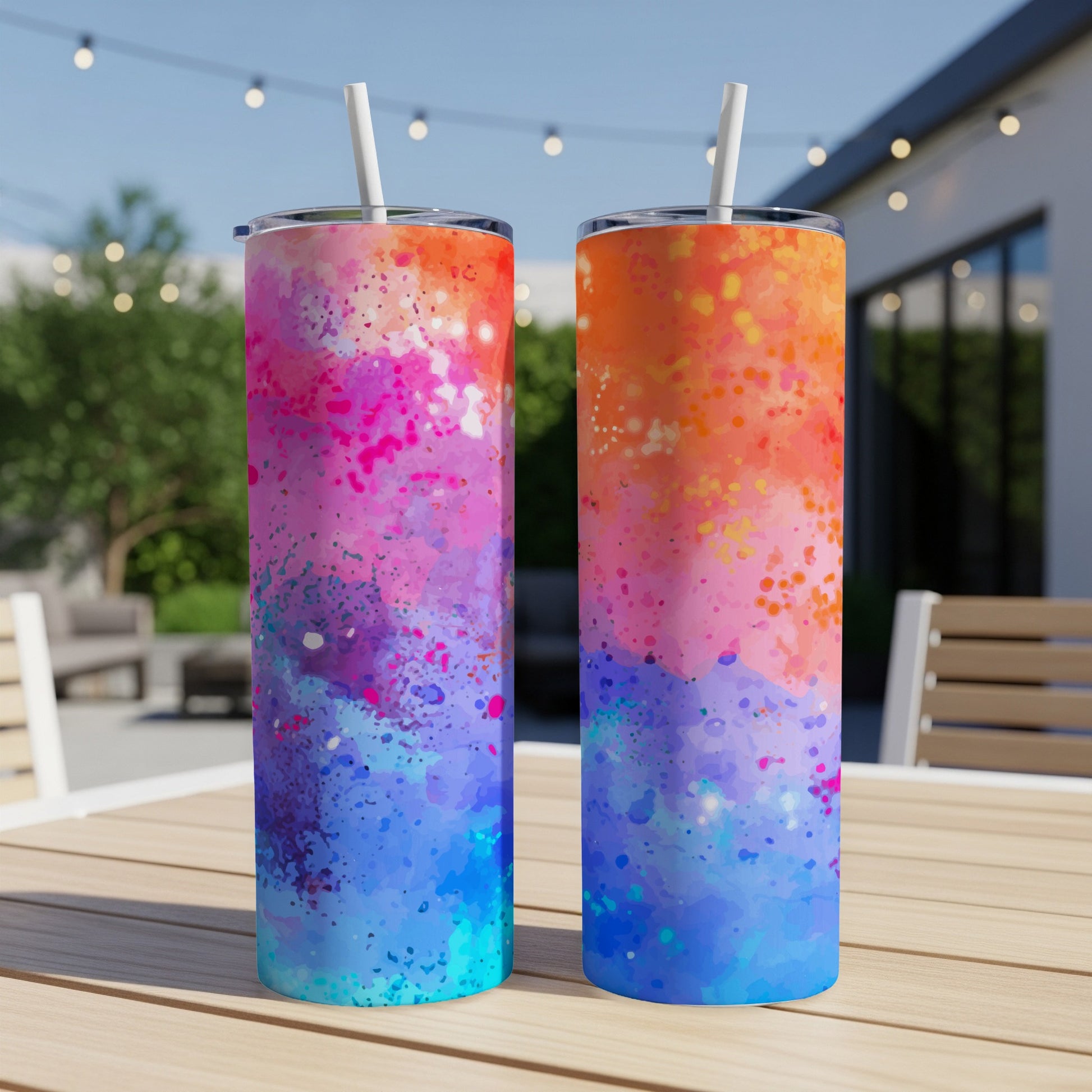 Two tumblers with watercolor splatter designs in pink, orange, purple, and blue.