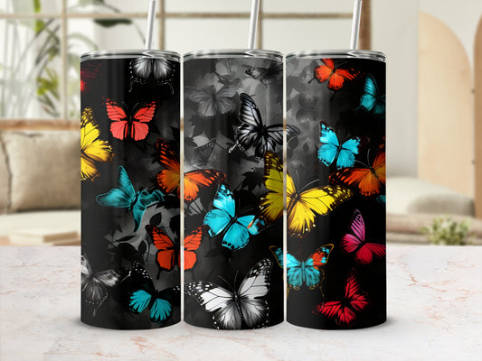 Three stainless steel tumblers with colorful butterfly designs on a black background.