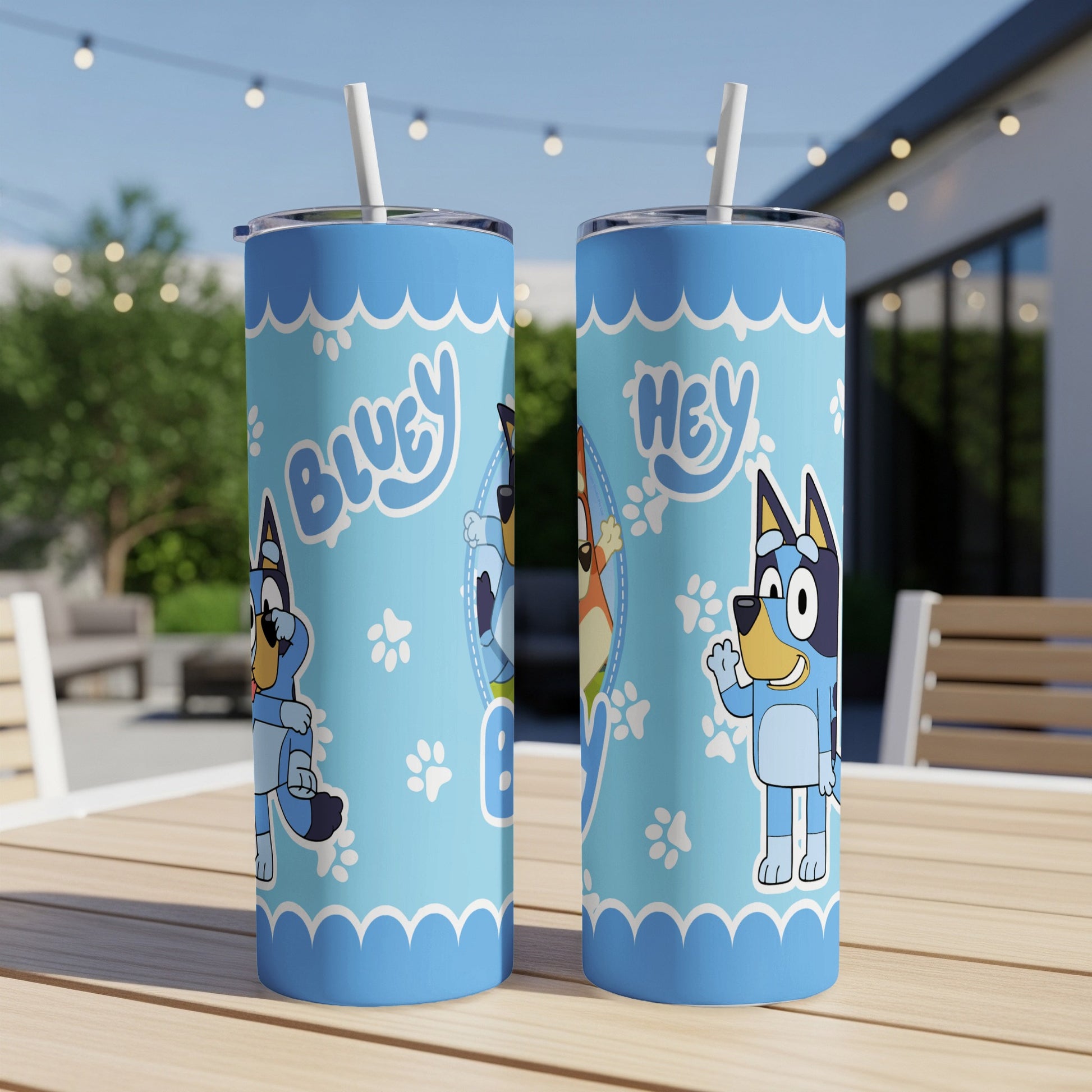 Bluey and Bingo characters on a blue patterned tumbler cup.