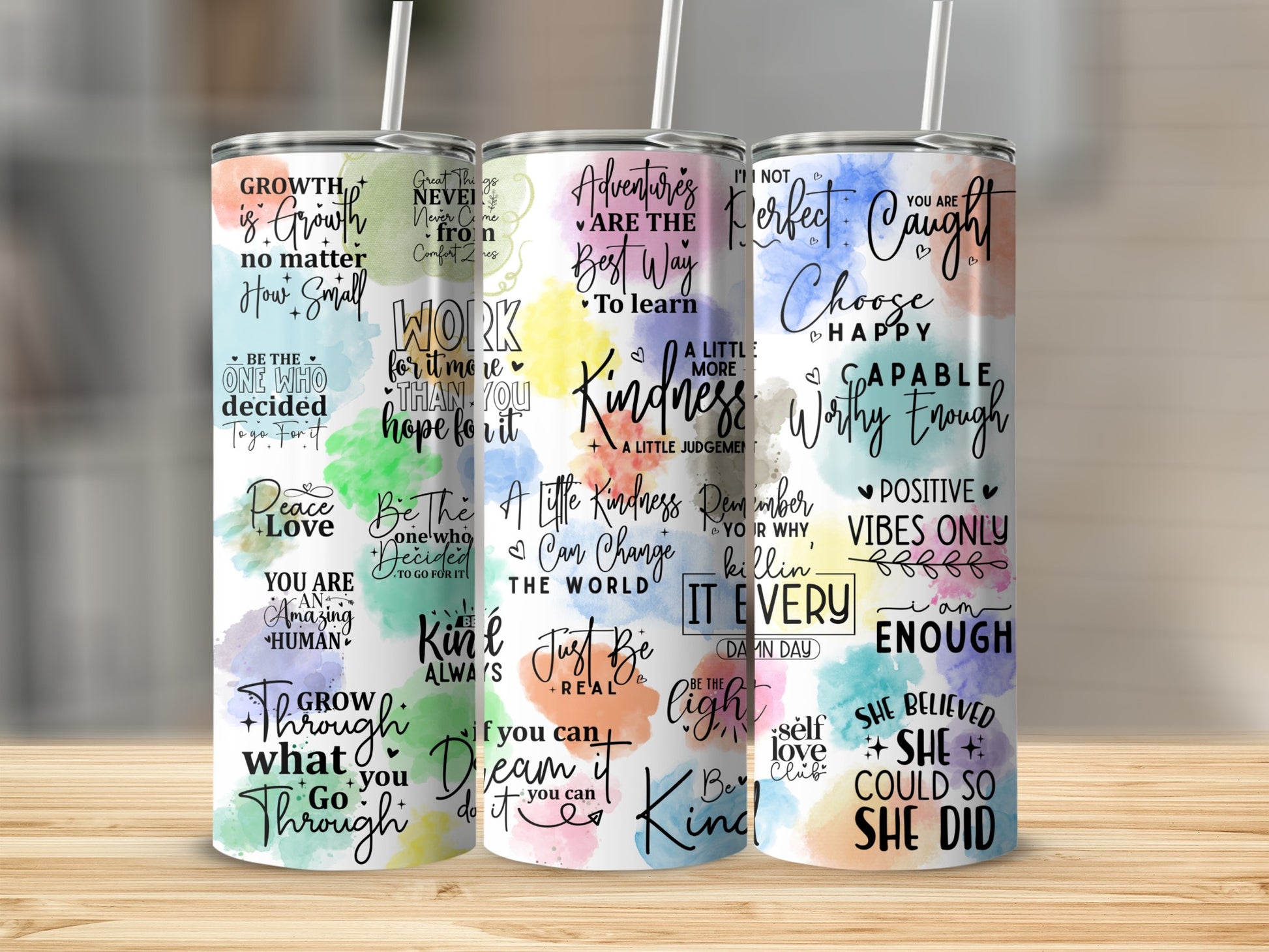 Three tumblers with motivational quotes and colorful backgrounds.