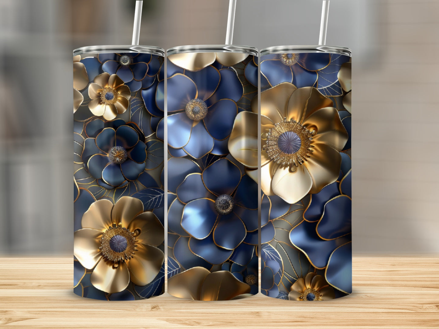 Three tumblers with blue and gold floral patterns on a wooden surface.