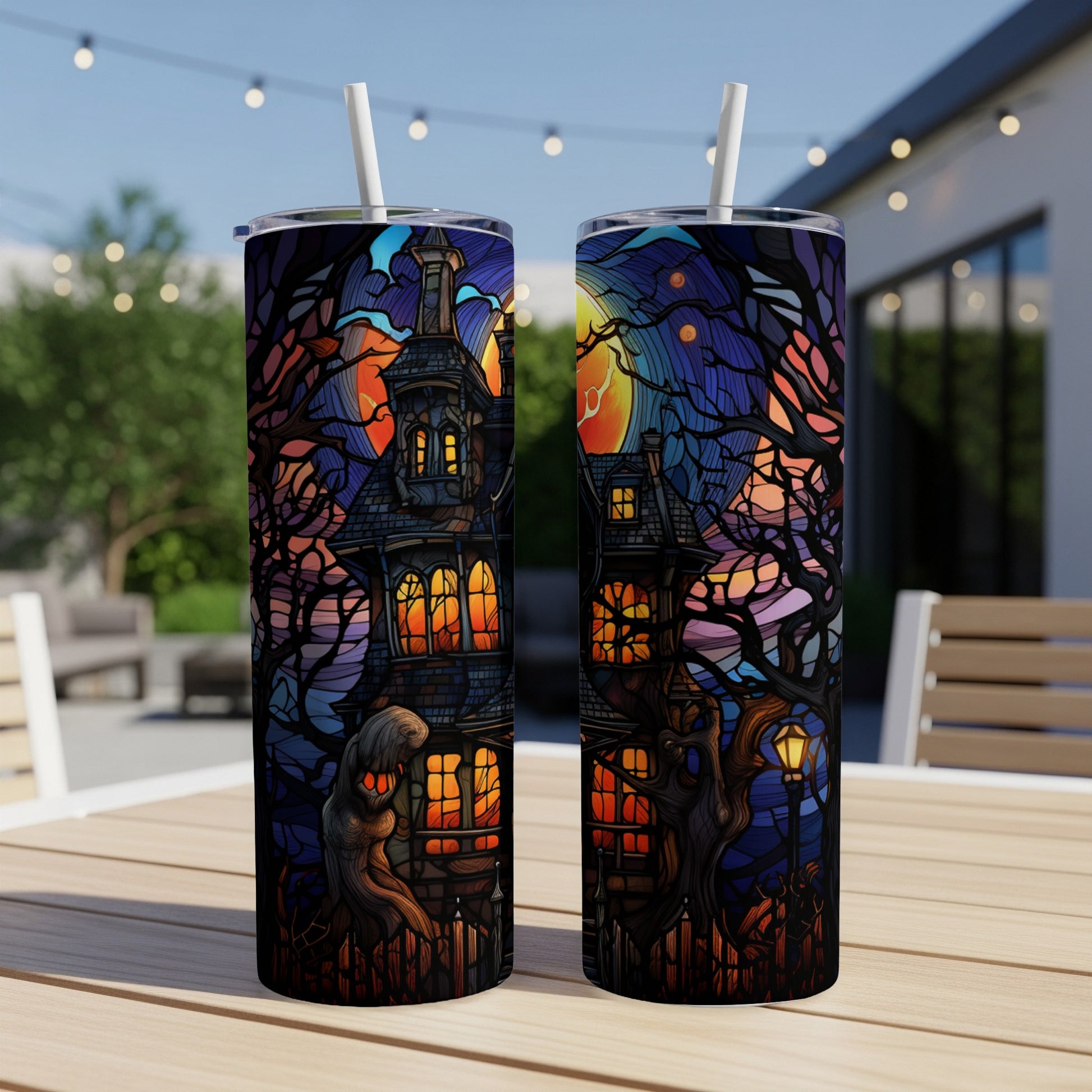 Two skinny tumblers with stained glass Halloween haunted house design.